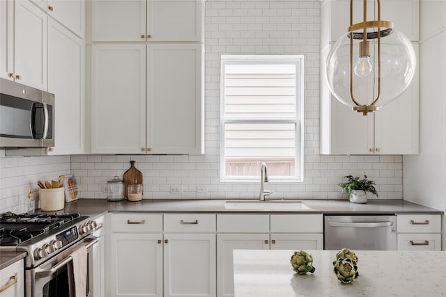 kitchen featuring sink, white cabinetry, and appliances with stainless steel finishes