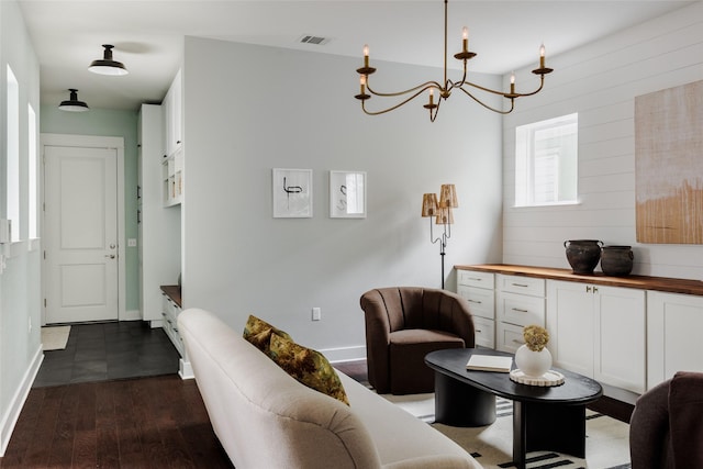 living room featuring dark hardwood / wood-style flooring and a chandelier