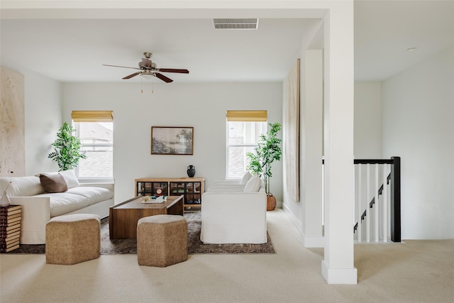 living room featuring light carpet and ceiling fan