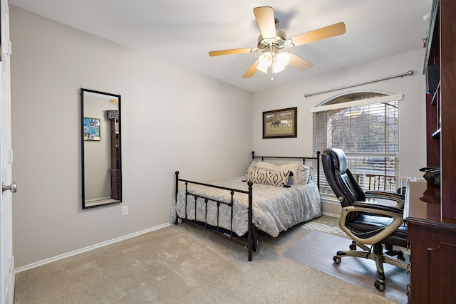 bedroom with ceiling fan and light carpet