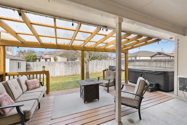 wooden terrace with an outdoor living space with a fire pit and a hot tub