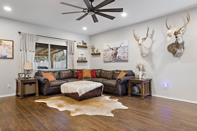 living room featuring ceiling fan and dark hardwood / wood-style floors