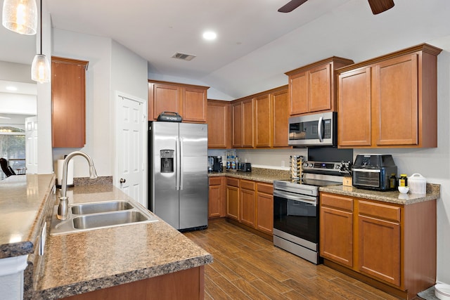 kitchen featuring decorative light fixtures, appliances with stainless steel finishes, ceiling fan, and sink