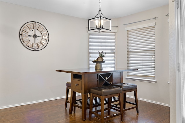 dining space featuring an inviting chandelier and dark wood-type flooring