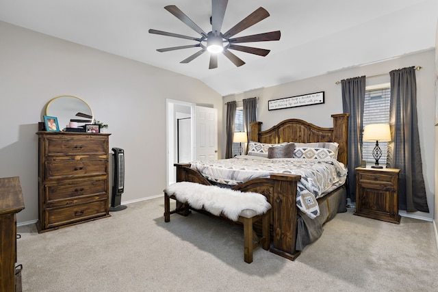 carpeted bedroom with vaulted ceiling, ceiling fan, and multiple windows