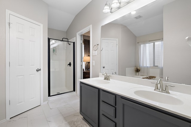 bathroom with lofted ceiling, a shower with door, and vanity