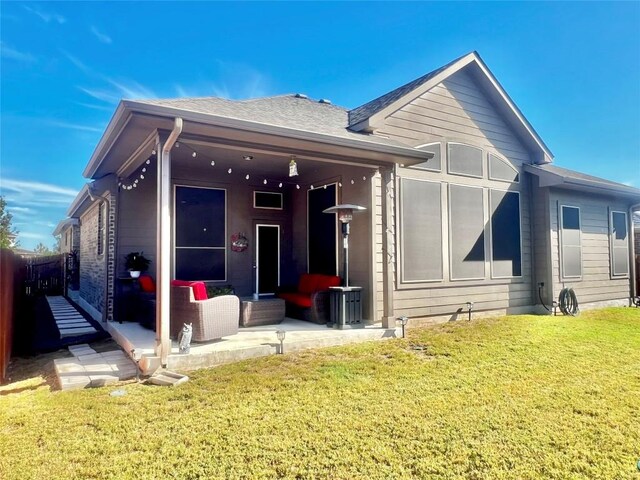 back of house featuring a yard and a patio area