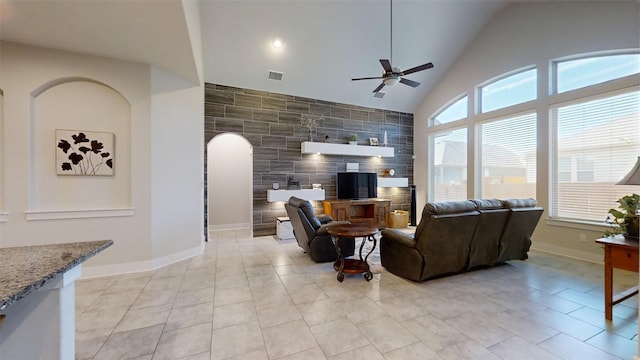 tiled living room featuring high vaulted ceiling and ceiling fan