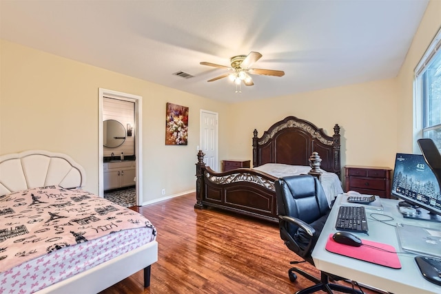 bedroom featuring baseboards, visible vents, a ceiling fan, connected bathroom, and wood finished floors