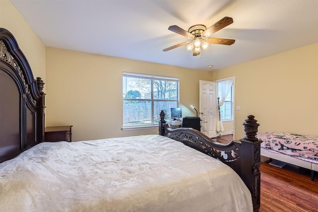 bedroom with dark wood-type flooring and ceiling fan