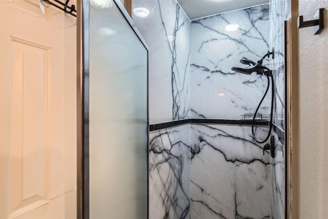 room details featuring a marble finish shower