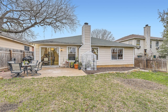 back of house featuring a yard, a chimney, a patio area, and fence private yard