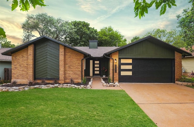 view of front of house with a garage and a yard