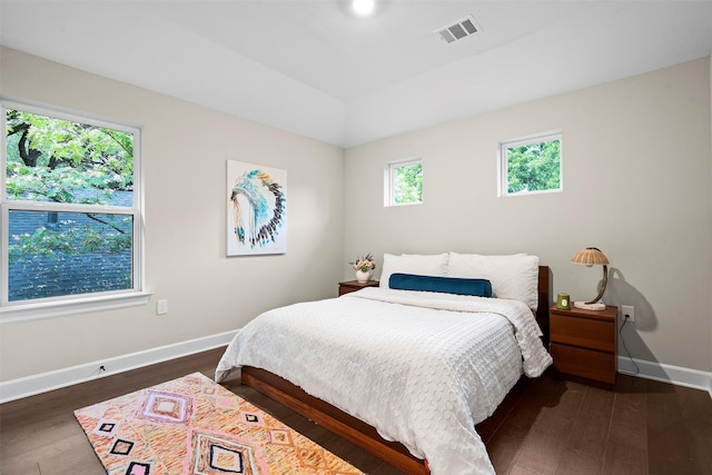 bedroom with dark hardwood / wood-style floors