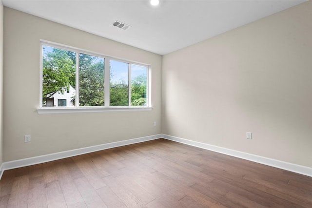 unfurnished room featuring hardwood / wood-style flooring