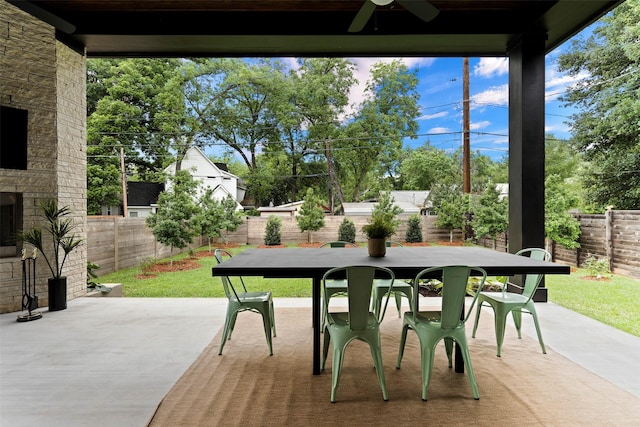 view of patio featuring ceiling fan and an outdoor stone fireplace