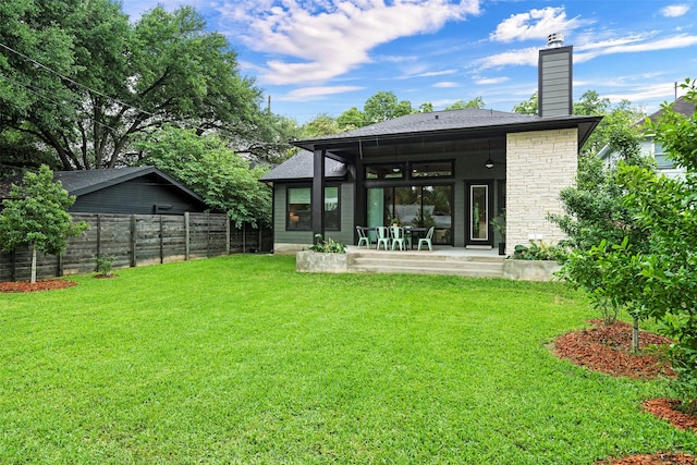 back of house featuring a patio, ceiling fan, and a lawn