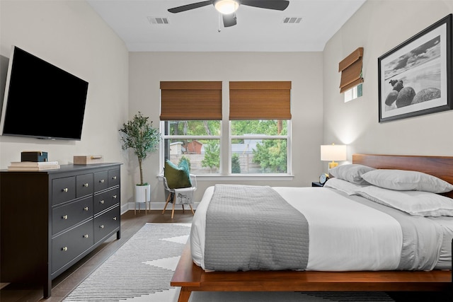 bedroom with ceiling fan and dark wood-type flooring