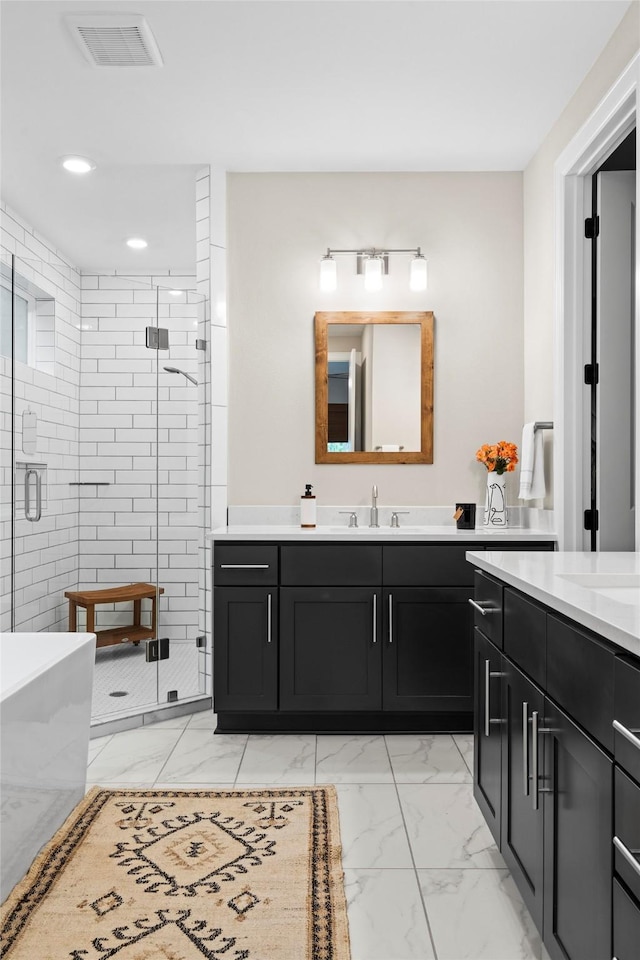 bathroom with a shower with door and vanity