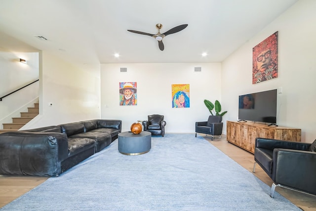 living room with ceiling fan and light hardwood / wood-style flooring