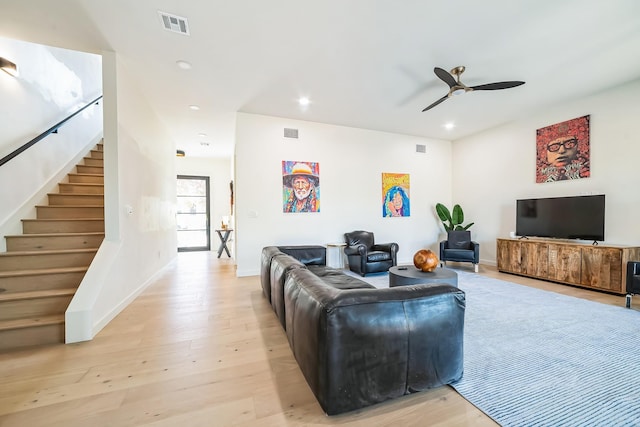 living room featuring ceiling fan and light wood-type flooring