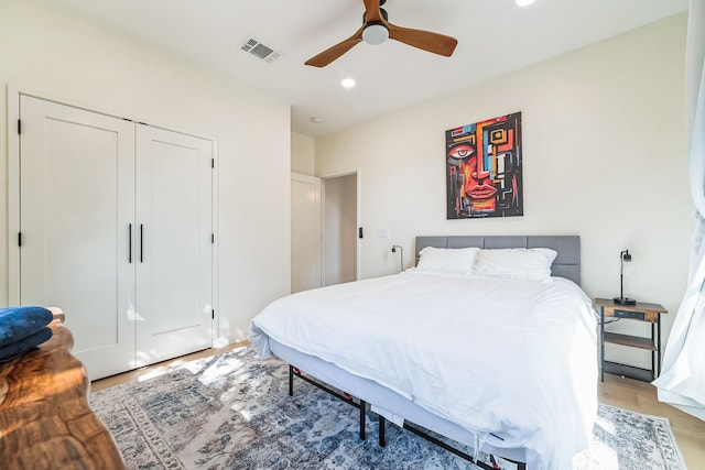 bedroom featuring wood-type flooring, a closet, and ceiling fan