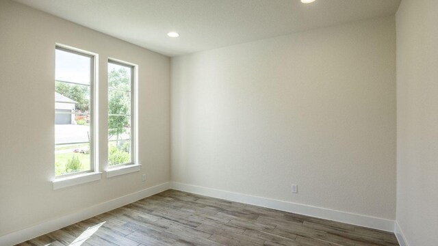 1728 Snowdrop Dr, Georgetown, TX 78628 - unfurnished room featuring healthy amount of natural light, recessed lighting, and wood finished floors