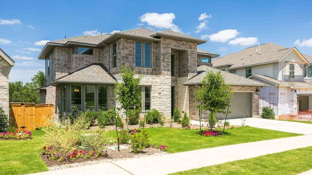 1728 Snowdrop Dr, Georgetown, TX 78628 - view of front of home featuring brick siding, a garage, concrete driveway, and roof with shingles