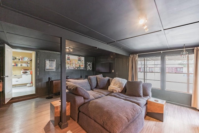 living room featuring built in shelves and wood finished floors