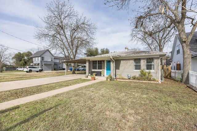 view of front of house with a front yard and a carport