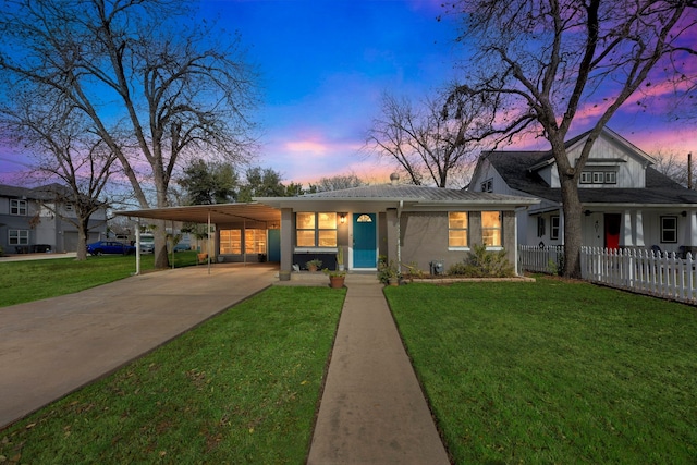 view of front of property with a carport and a lawn