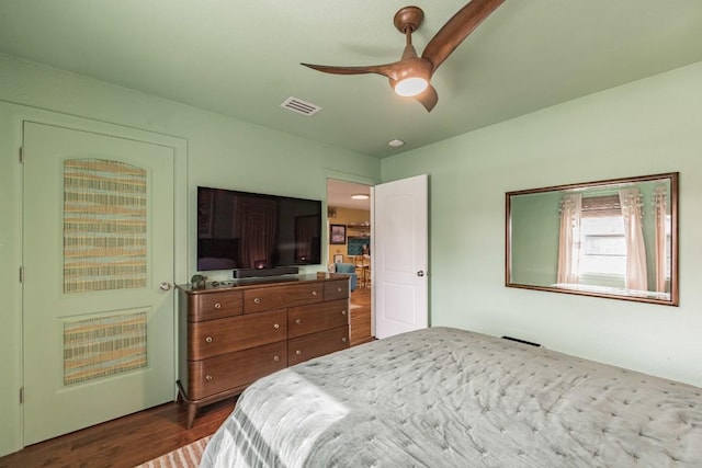 bedroom with visible vents, ceiling fan, and dark wood-style flooring