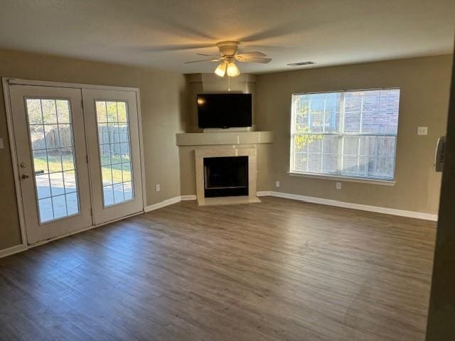 unfurnished living room featuring ceiling fan and dark wood-type flooring