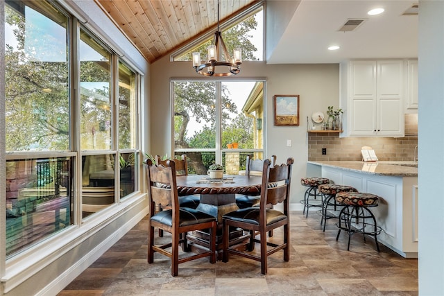 dining space featuring wooden ceiling, lofted ceiling, and a notable chandelier