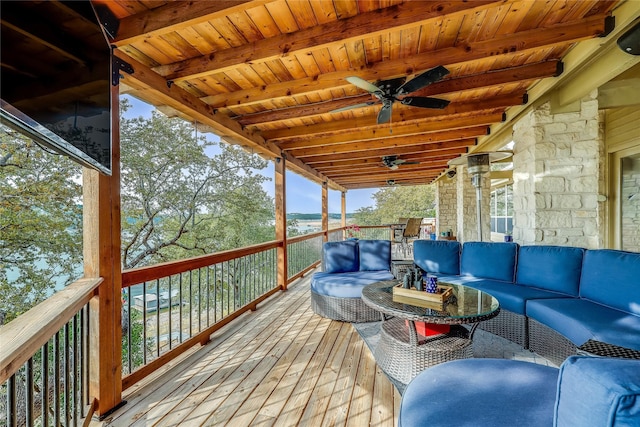 wooden deck with ceiling fan and outdoor lounge area