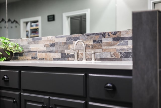 bathroom with vanity and tasteful backsplash