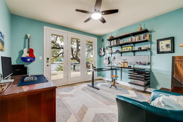 office space with light wood-type flooring and ceiling fan