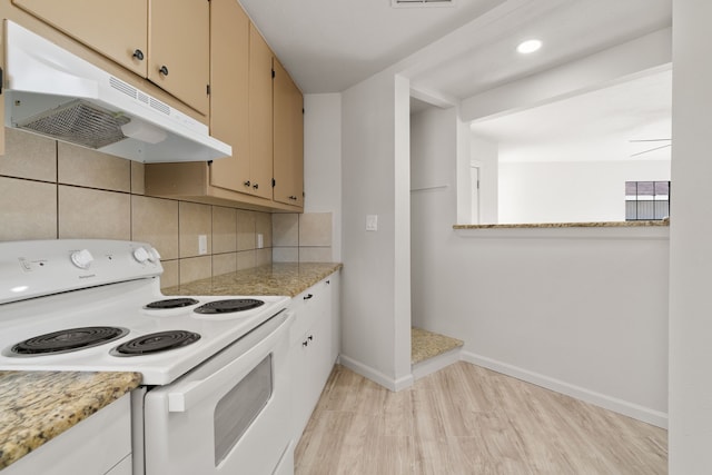 kitchen with light stone counters, light hardwood / wood-style floors, white electric stove, backsplash, and ceiling fan