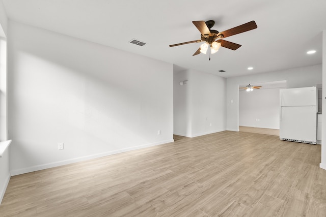 unfurnished living room featuring ceiling fan and light hardwood / wood-style flooring