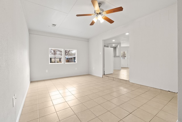 tiled empty room with ceiling fan