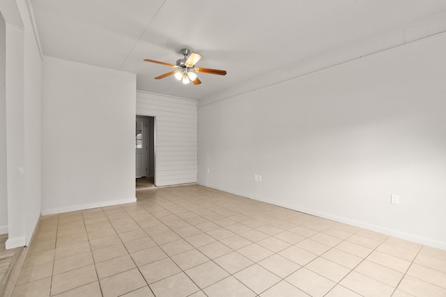 tiled spare room with ceiling fan and crown molding