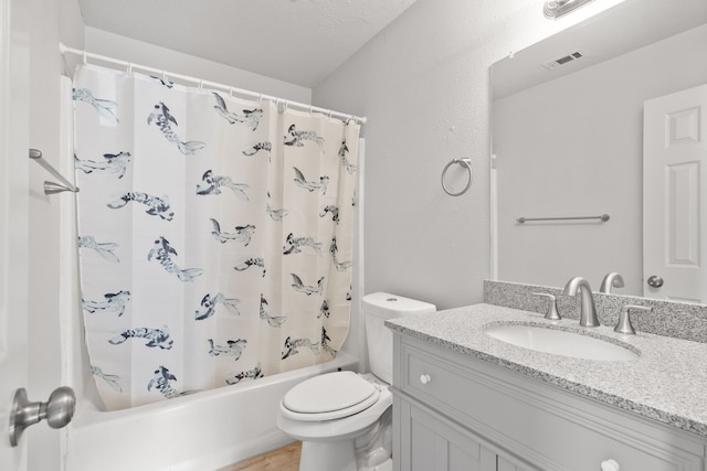 full bathroom with toilet, vanity, a textured ceiling, and shower / bath combo with shower curtain