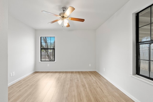 empty room with light wood-type flooring and ceiling fan