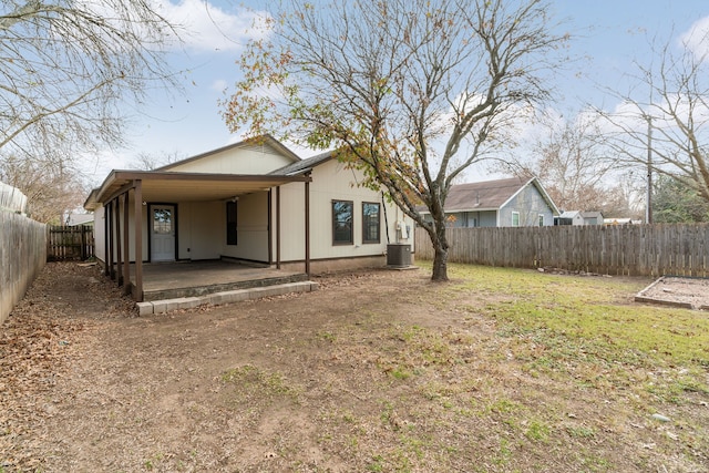 rear view of property with a patio area, cooling unit, and a lawn