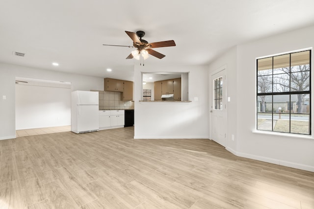 unfurnished living room featuring ceiling fan and light hardwood / wood-style flooring