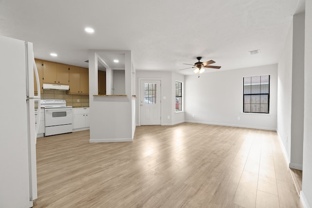 unfurnished living room with ceiling fan and light wood-type flooring