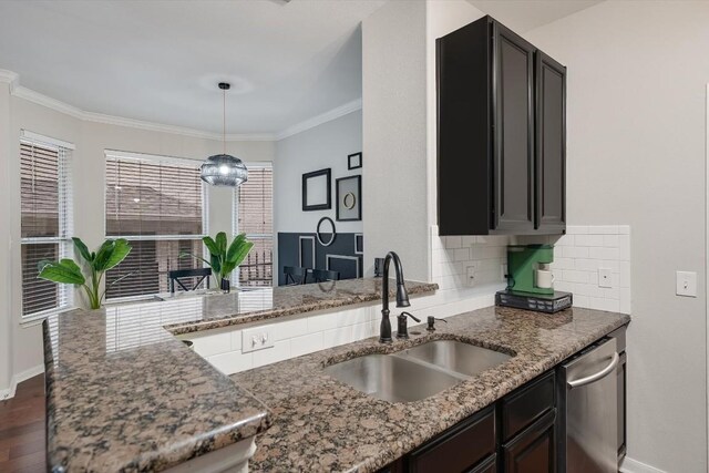 kitchen featuring dark hardwood / wood-style flooring, sink, stone countertops, hanging light fixtures, and kitchen peninsula