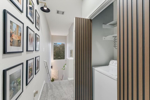 washroom featuring washer / dryer and carpet flooring