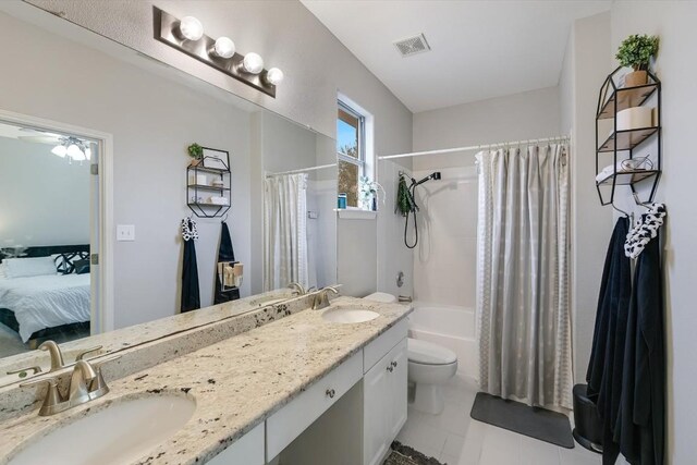 full bathroom with toilet, ceiling fan, tile patterned flooring, shower / tub combo, and vanity