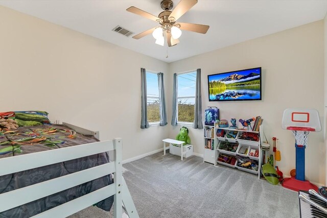 bedroom featuring ceiling fan and carpet